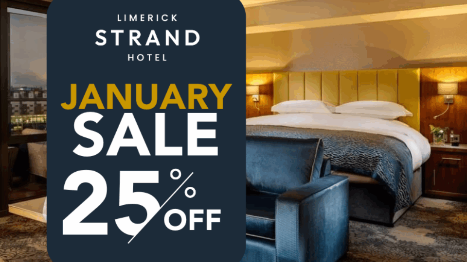 Hotel room with a large bed and seating area; a sign in front reads