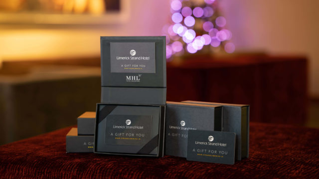 Five black gift boxes labeled 
